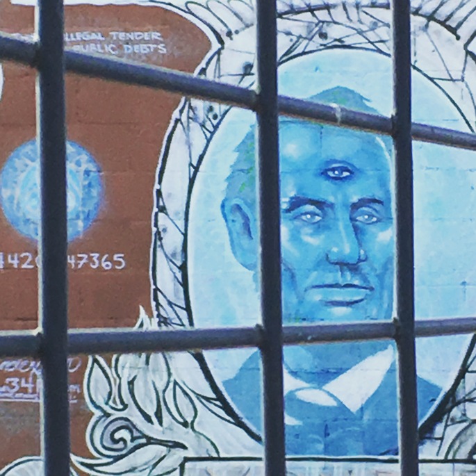 Graffiti of three-eyed Abraham Lincoln on dollar bill, on wall of Dallas, Texas graffiti park